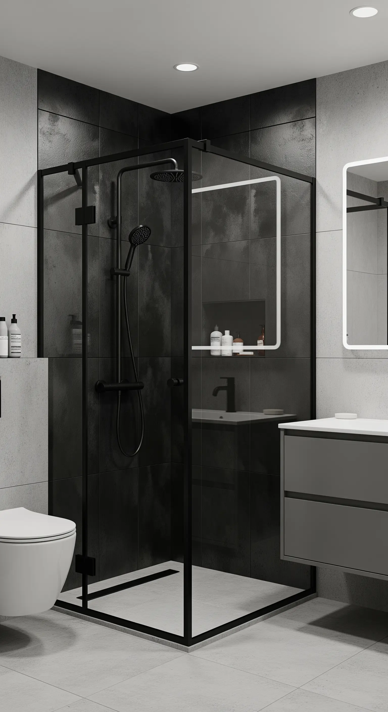 Bagno con piastrelle grigio chiaro e piastrelle scure all'interno del box doccia nero.