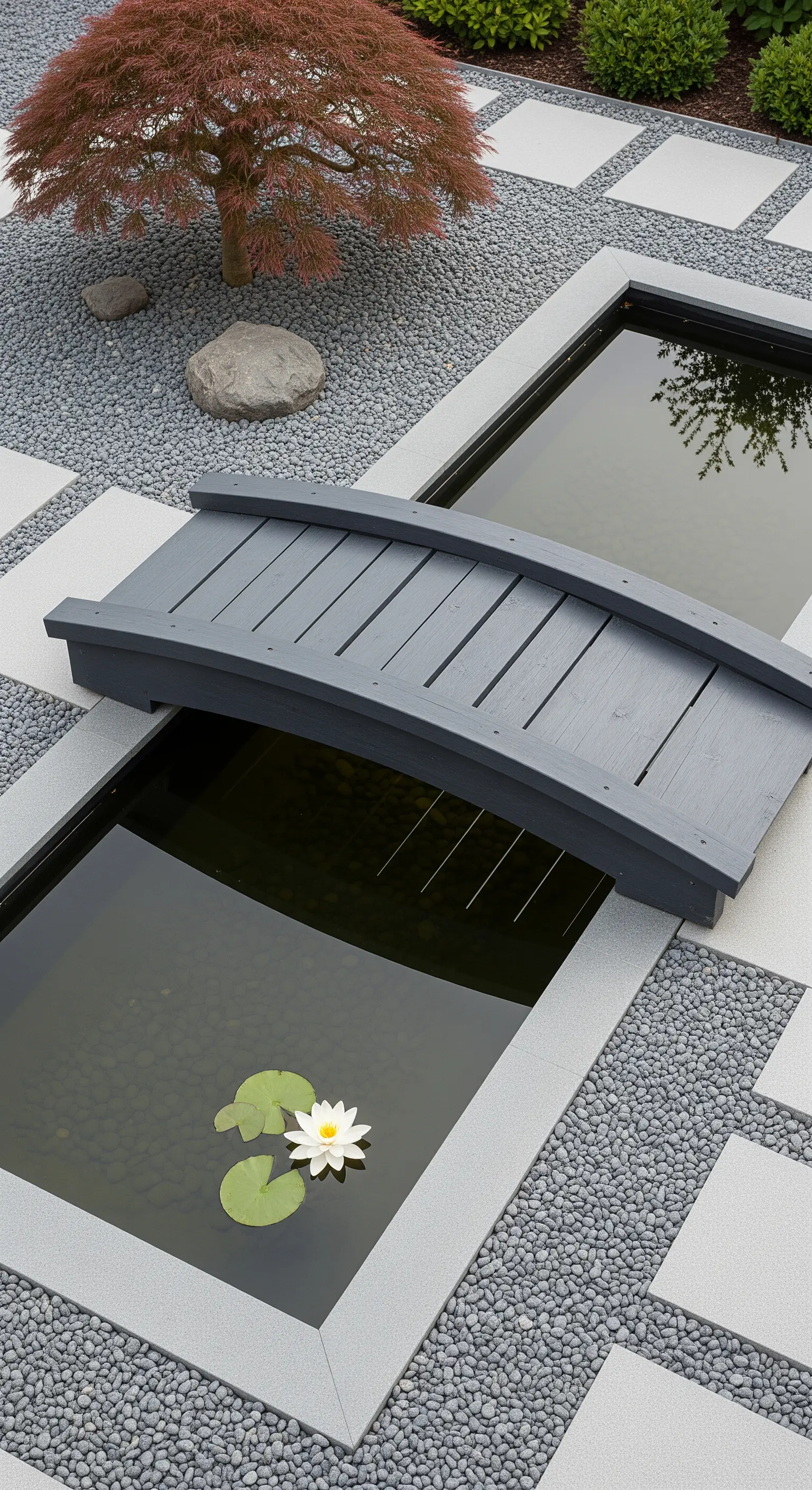 Ponte moderno grigio ad arco su vasche d'acqua rettangolari in un giardino minimalista