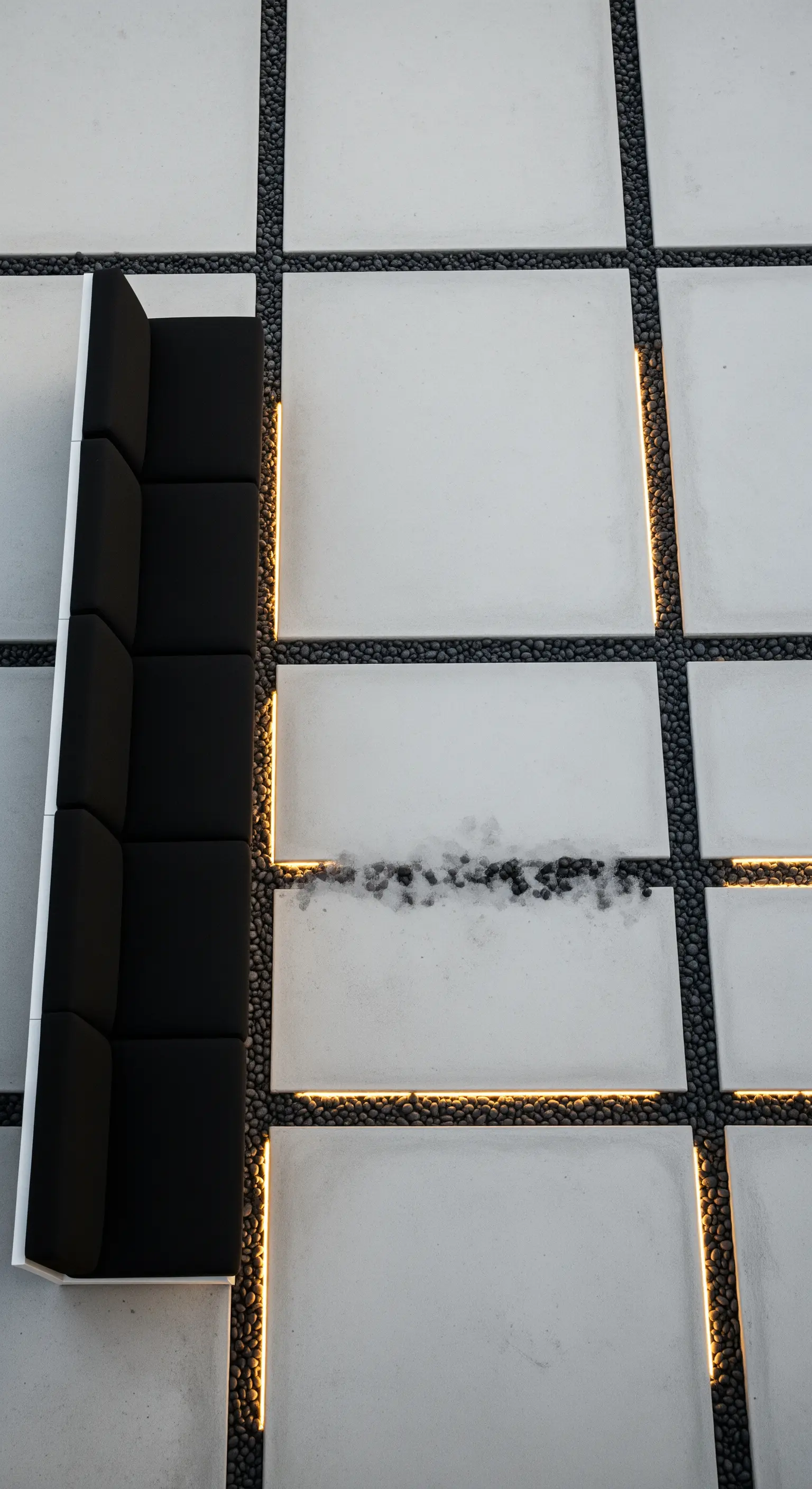 Pavimentazione in cemento e ciottoli neri con linee di luce a LED integrate nel disegno.