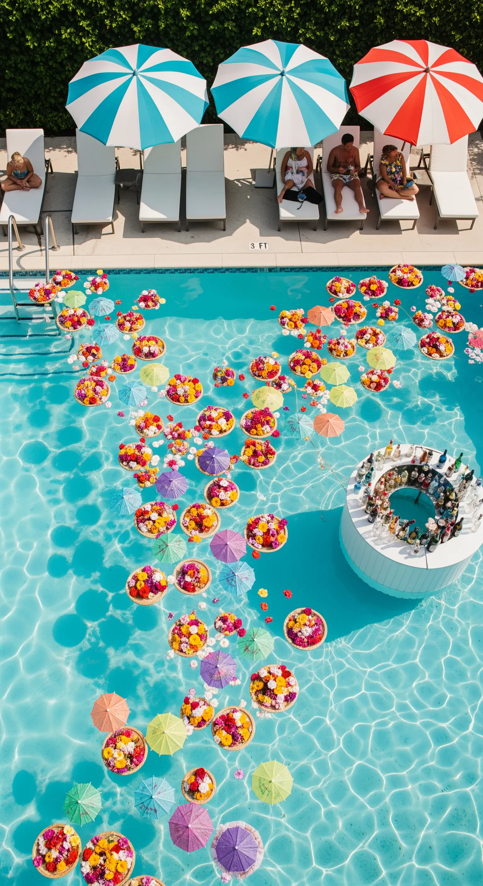 Piscina piena di fiori e ombrellini galleggianti con un bar circolare al centro
