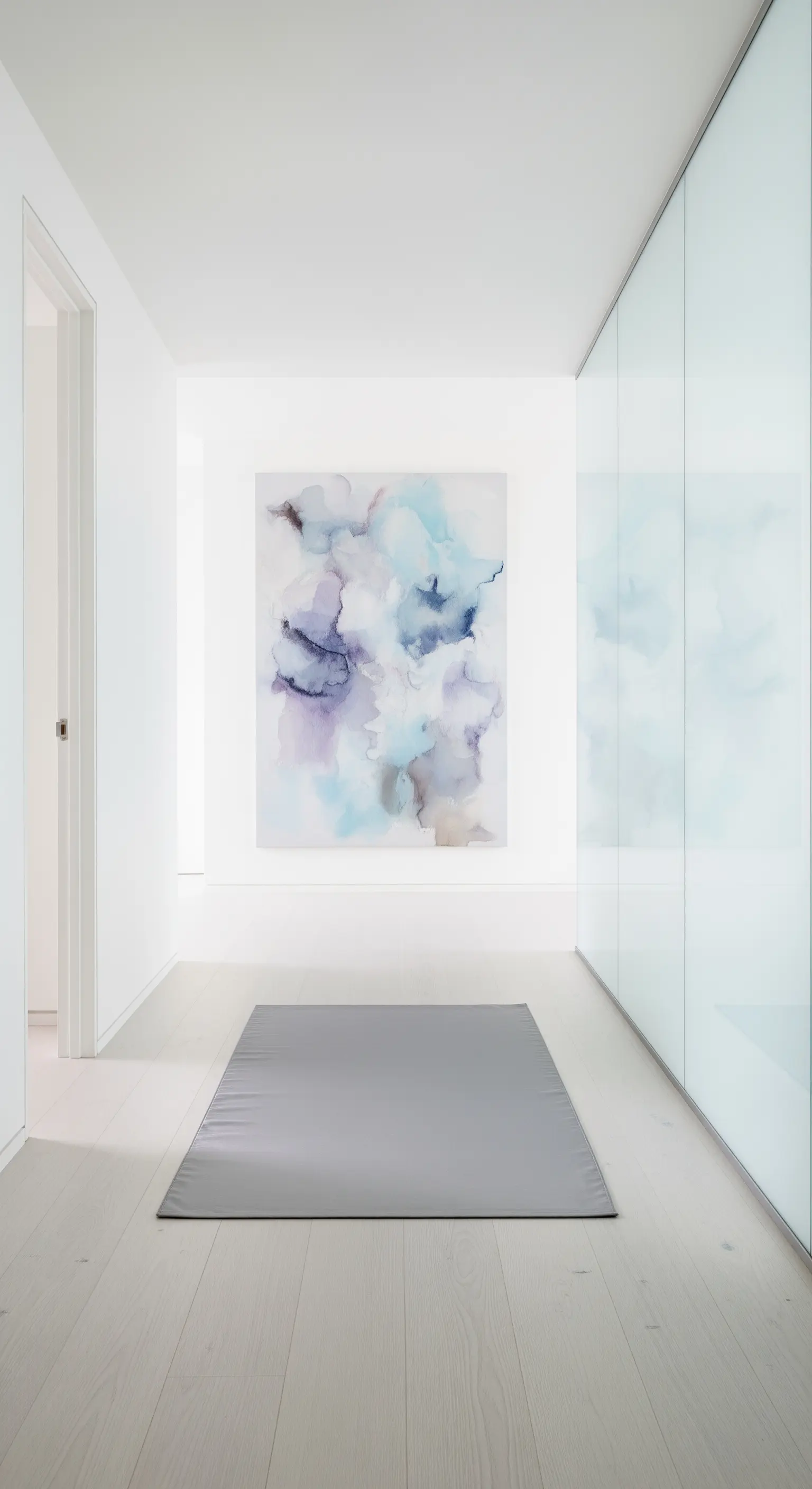 Corridoio bianco minimalista con quadro astratto ad acquerello e parete in vetro satinato.